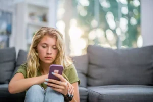 a lonely woman scrolling on her cell phone