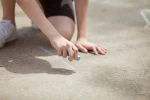 a person writing on the ground with chalk for Epiphany