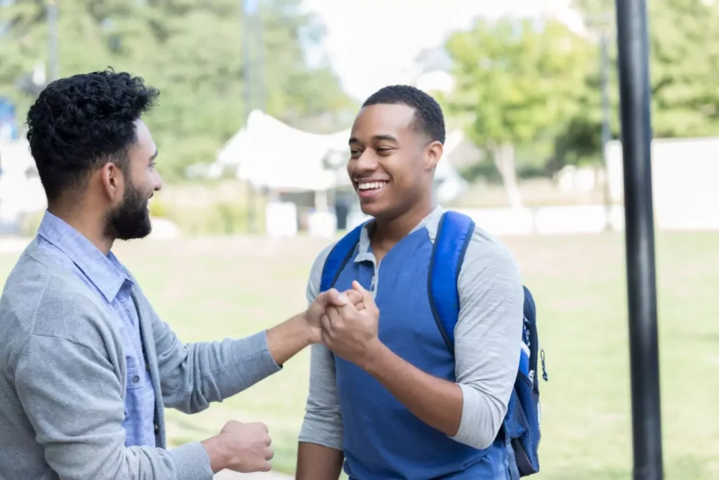 two guys greeting each other, showing chivalry to one another