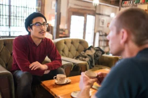 a guy talking to his friend, confessing his sin