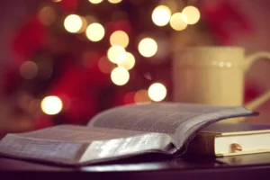 a Bible in front of a Christmas tree - keeping Christmas all year round