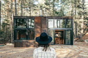 a woman standing in front of a house considering living together with her boyfriend