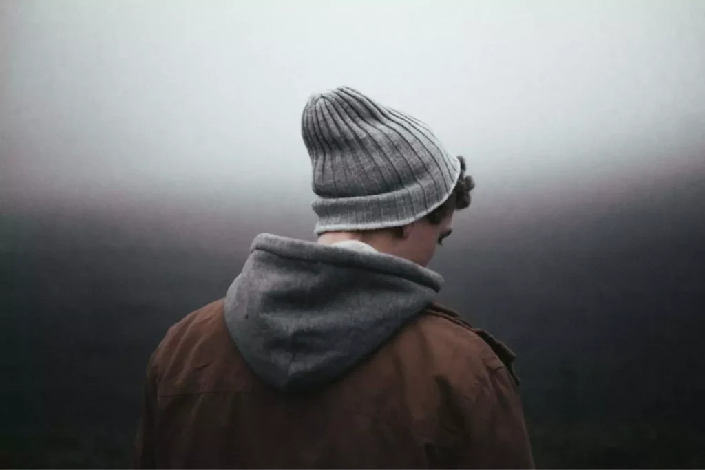 a man waiting in the fog