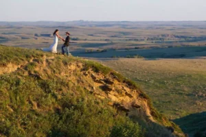 wedding on a hillside, groom wearing a cowboy hat