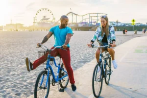 a guy and a girl riding bikes and having fun