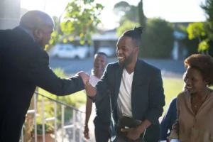 a man giving his pastor a fist bump as he walks into church