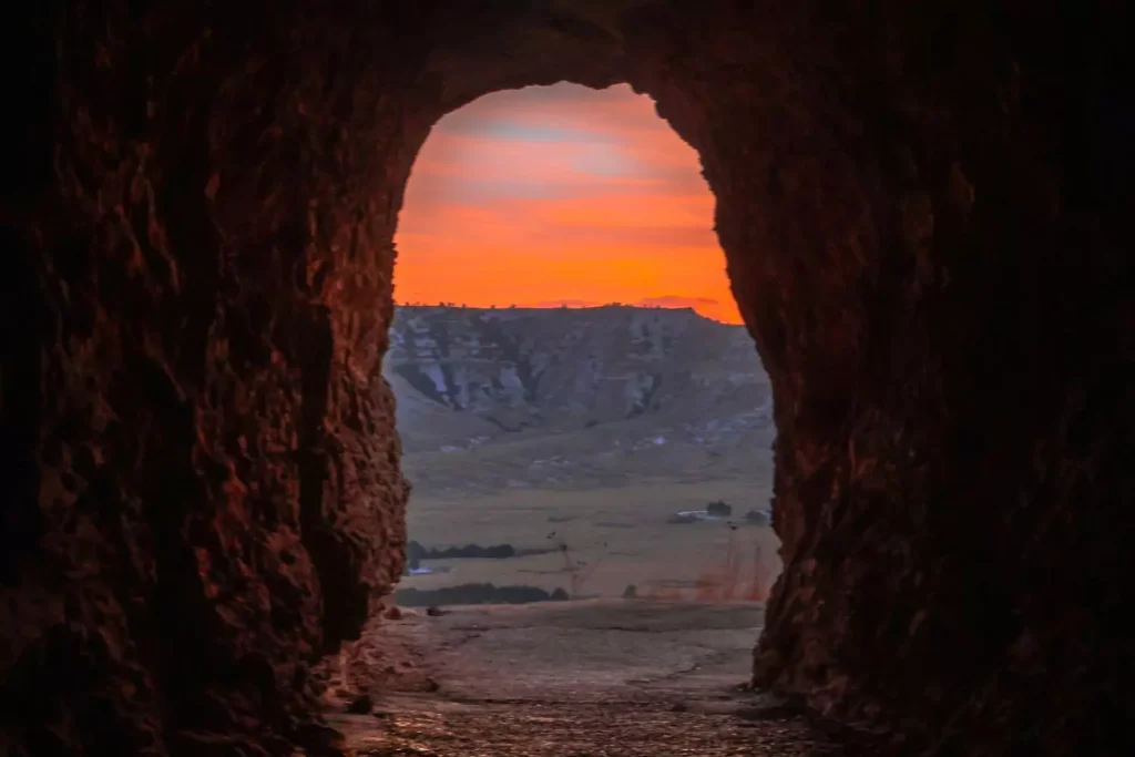 an open tomb at sunset, representative of Easter