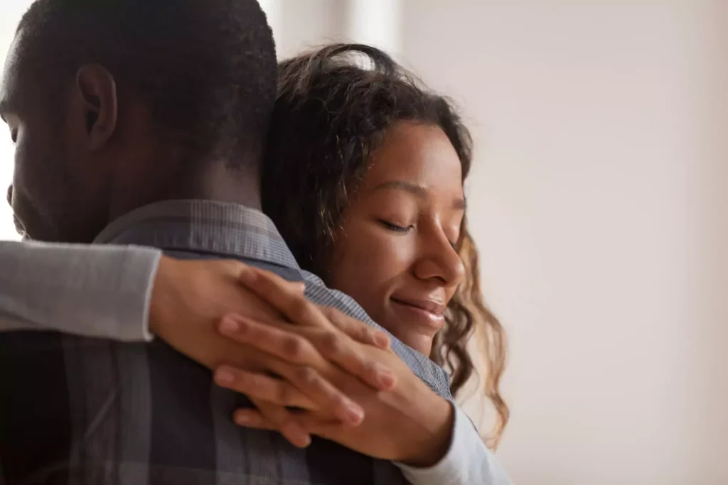 a woman hugging her husband, experiencing love and forgiveness