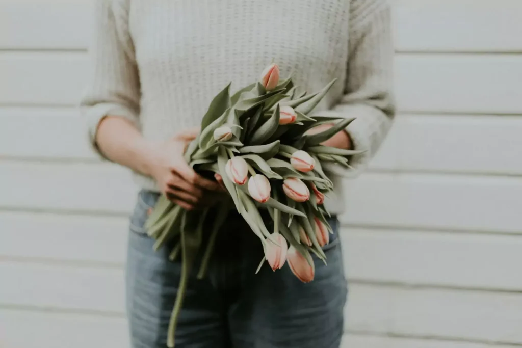 a woman holding tulips, her love language is gifts