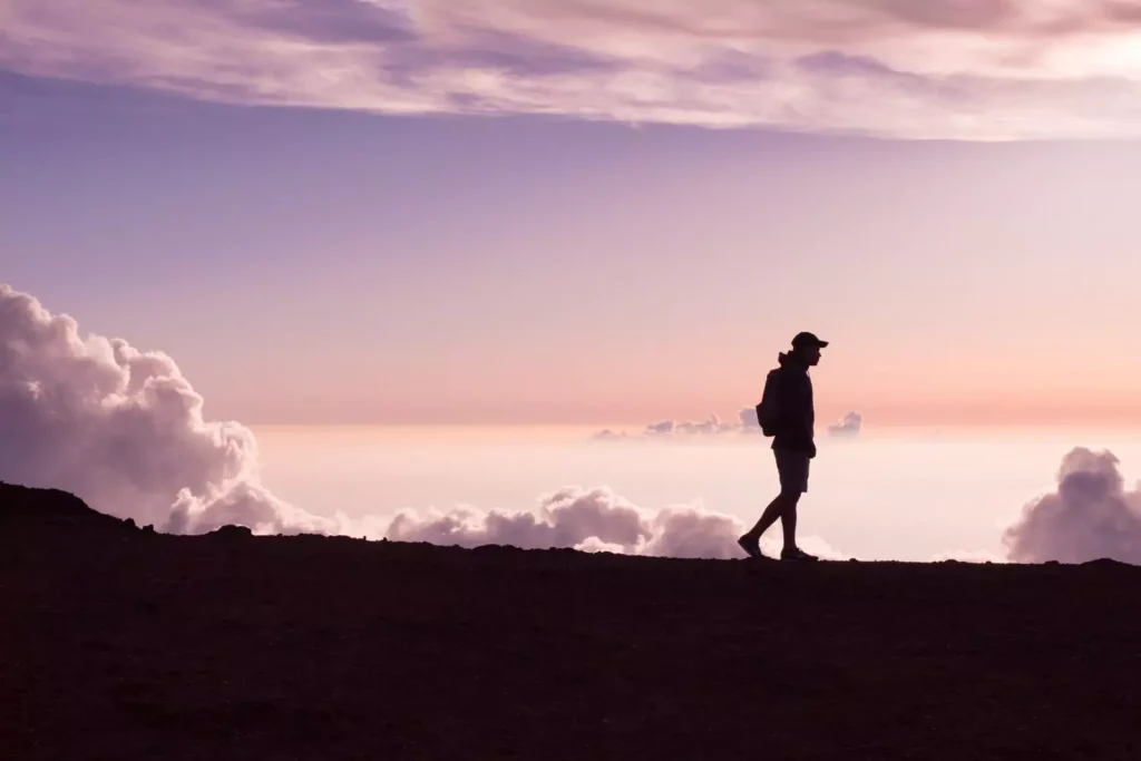 a silhouette of a man walking during a purple sunset. He has the gift of singleness