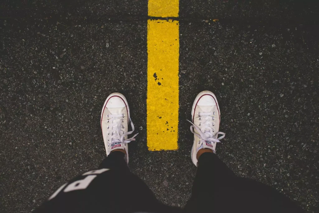 an image of a man's shoes standing on the street, a symbol of leading