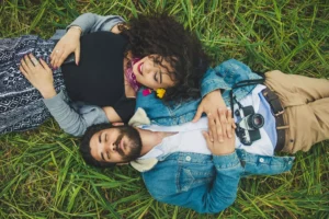 a couple laying in the grass, talking about boundaries