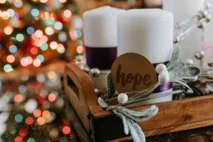 Advent candles with a Christmas tree in the background